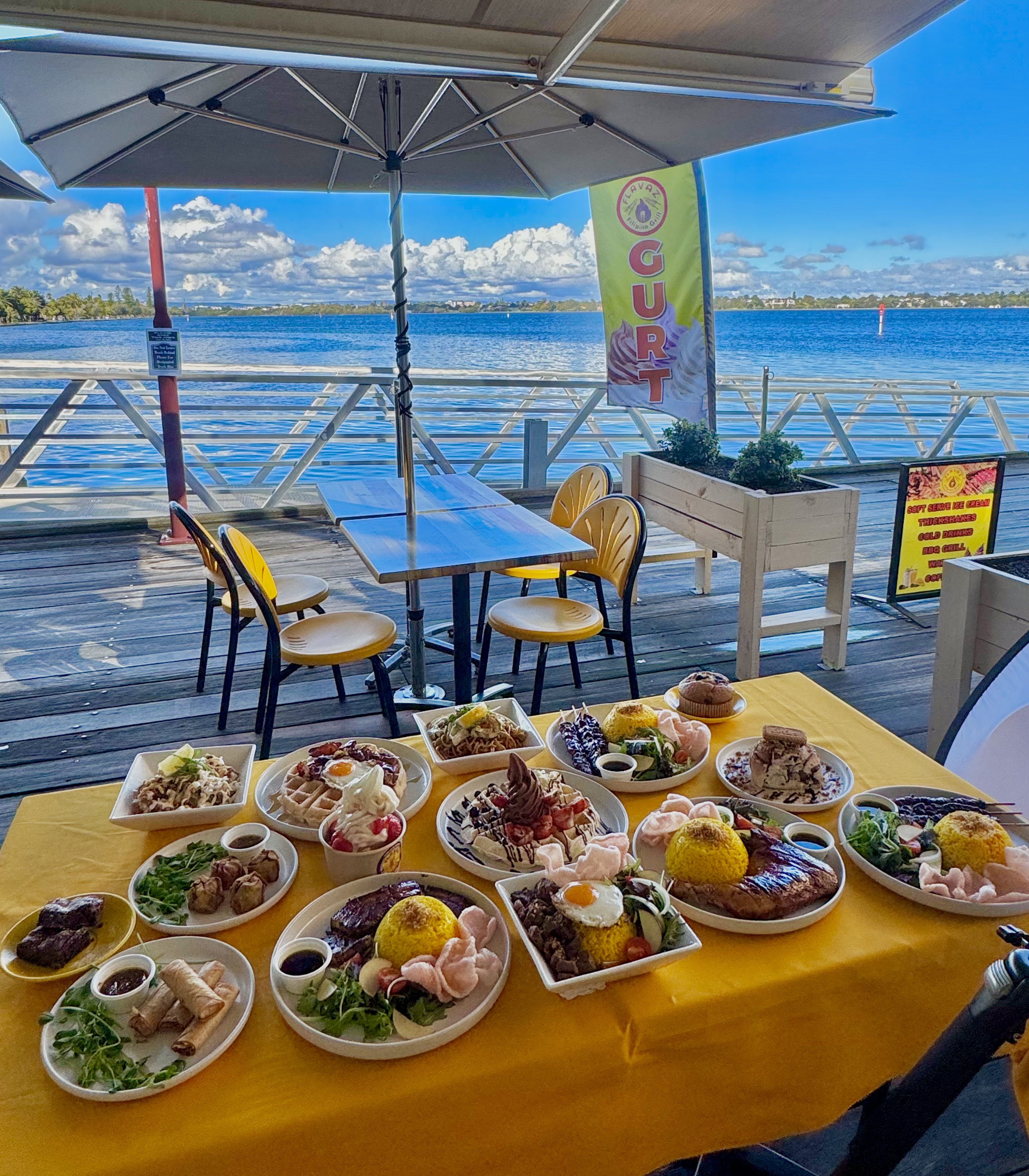 Flavaz Filipino food spread with Swan River waterfront view